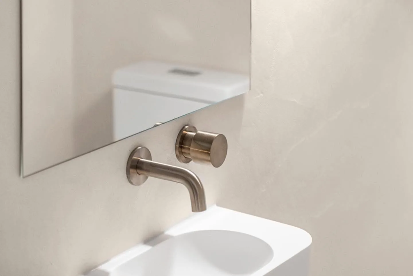 Microcement bathroom with brass tapware