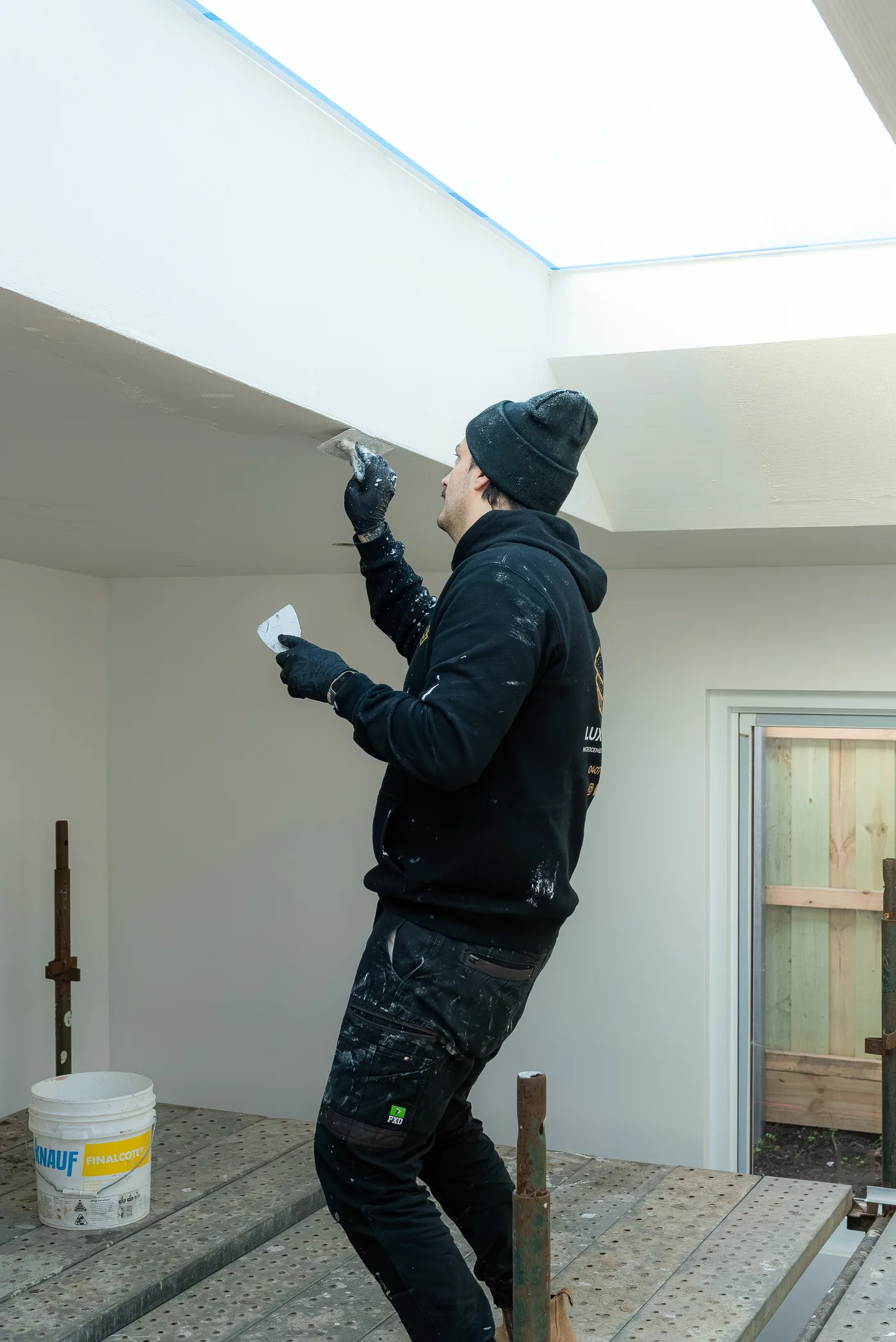 Lux Cement applicator trowelling around a skylight on site
